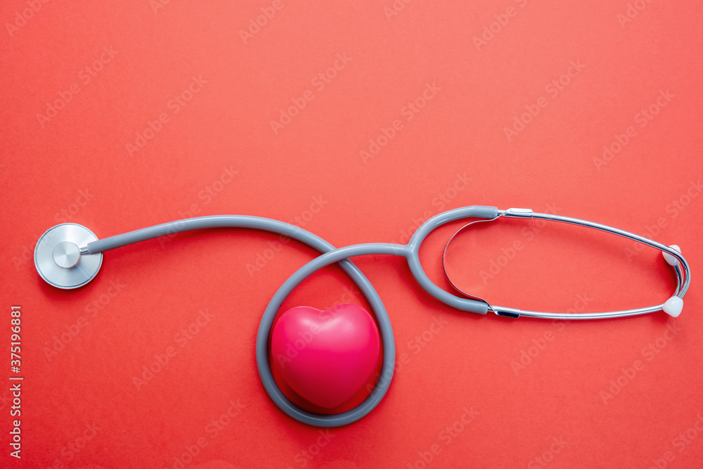 Stethoscope on red background. Health checkup cardio diagnosis concept. Stethoscope on red background. Health checkup cardio diagnosis concept.