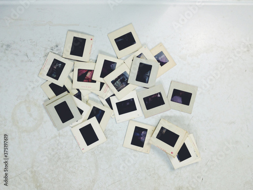 Vintage 35mm film slides on an old white table