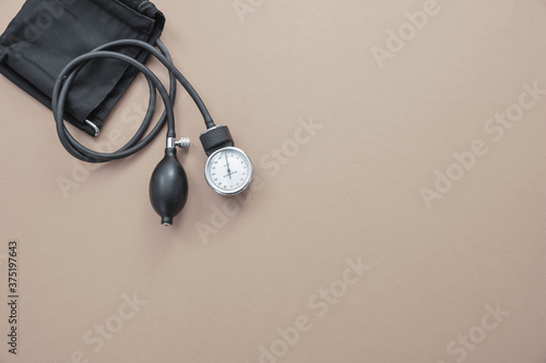 Medical sphygmomanometer on brown background, top view. photo