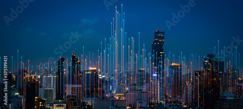 Fototapeta Naklejka Na Ścianę i Meble -  Modern city with wireless network connection and city scape concept.Wireless network and Connection technology concept with city background at night.