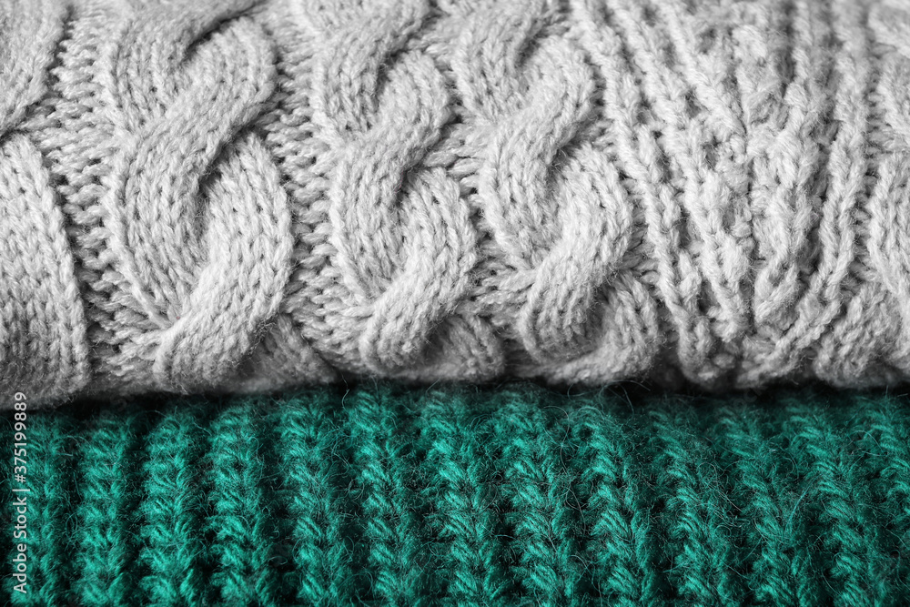 Folded warm sweaters as background, closeup view Folded warm sweaters as background, closeup view