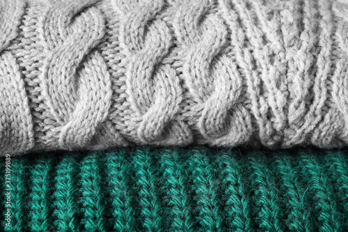 Folded warm sweaters as background  closeup view
