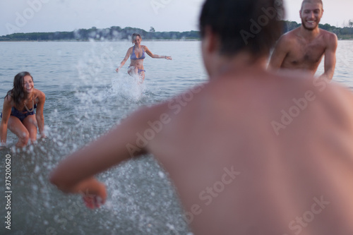 Friends Swimming During Sunset