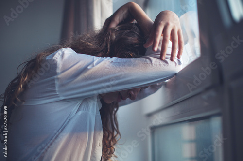 Tableau sur toile Sad teen near window