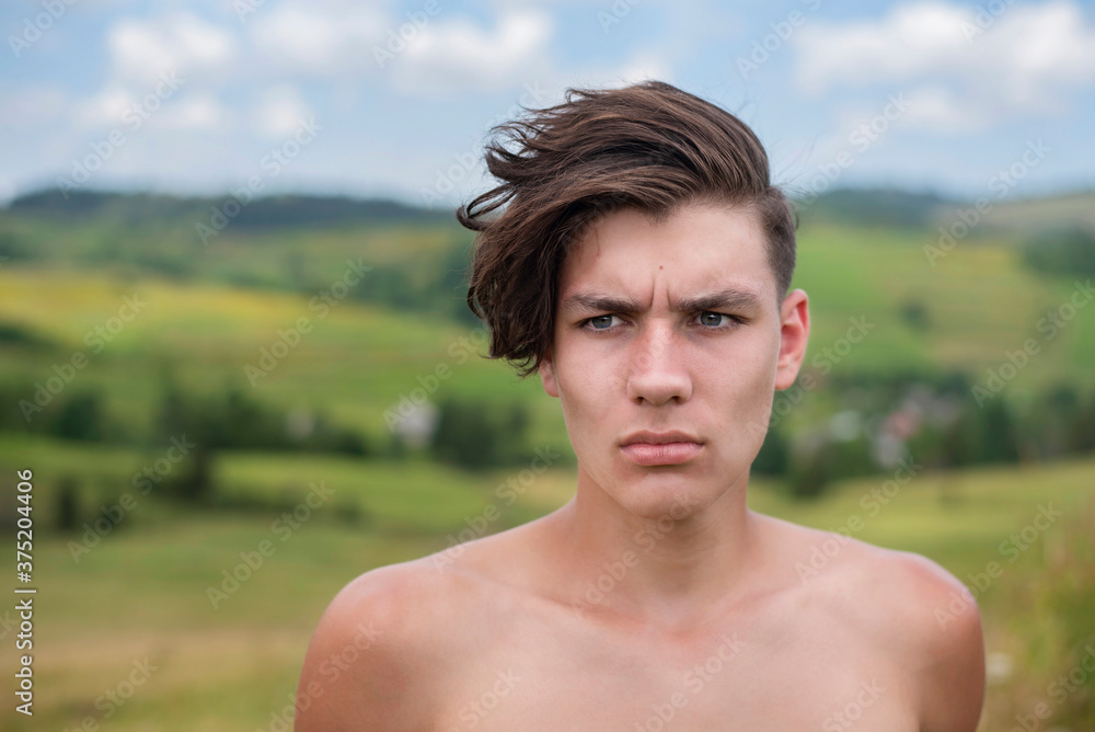 A teenage boy of sports nature trains in the mountains, gaining strength and courage before the next performance in the ring. The guy has a serious face and strong charisma A teenage boy of sports nature trains in the mountains, gaining strength and courage before the next performance in the ring. The guy has a serious face and strong charisma