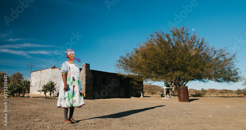 Namibian Nama woman standing outside her home photo