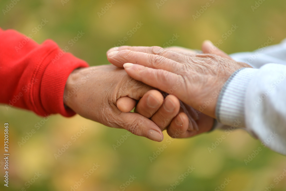 Hands of senior Couple, cropped background close-up Hands of senior Couple, cropped background close-up