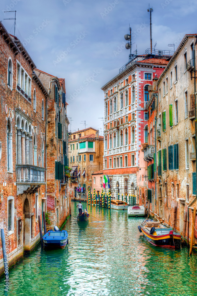 Gondola Passing through a Canal in Venice