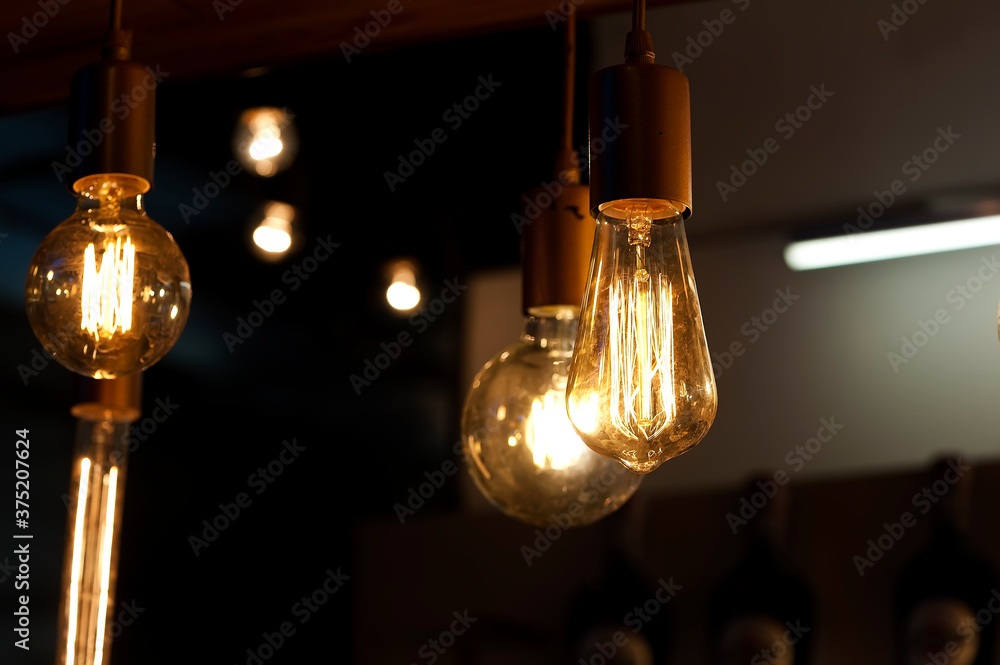 Light bulbs, lamps hanging on wires