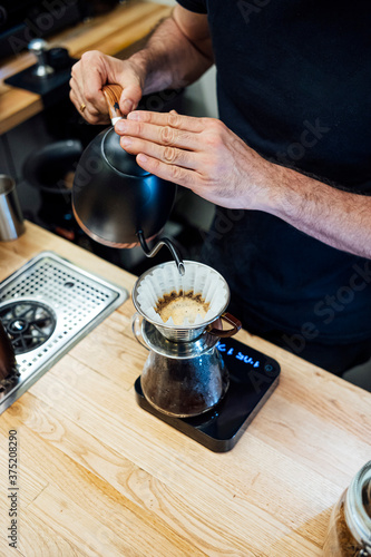 Barista preparing coffee with filter