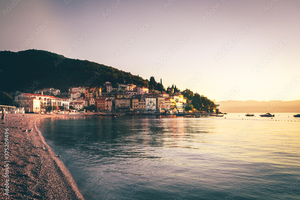 Sunrise in Moscenicka Draga in Istria, Croatia.  already photographed over the sandy beach and the sea while the sun rises and the beautiful old houses shine on