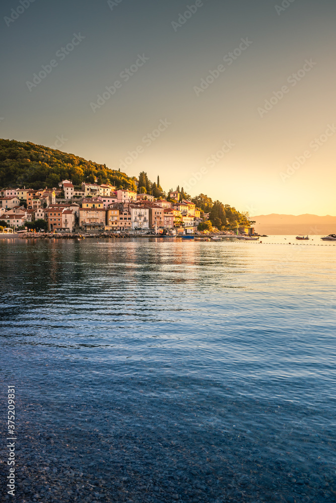 sunset over the sea, Sunrise in Moscenicka Draga in Istria, Croatia.  already photographed over the sandy beach and the sea while the sun rises and the beautiful old houses shine on