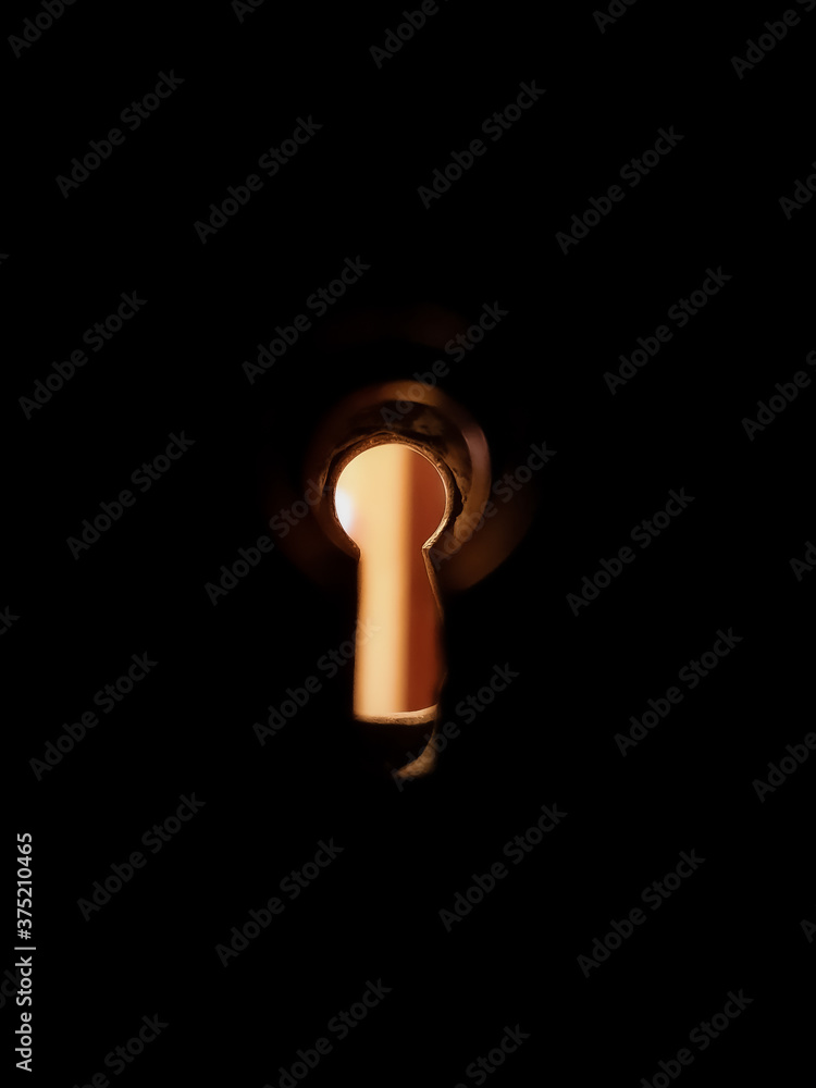 Keyhole on a black background, low yellow light Keyhole on a black background, low yellow light