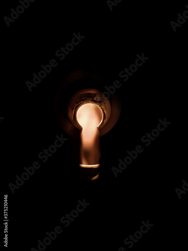 Keyhole on a dark background, yellow low light