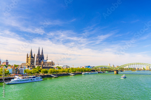 Cologne cityscape of historical city centre with Cologne Cathedral and Great Saint Martin Roman Catholic Church buildings, Hohenzollern Bridge across Rhine river, North Rhine-Westphalia, Germany photo