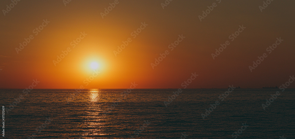 The beautiful sky background at sunrise or sunset on the waterfront sea shore in summer.