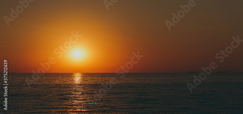 The beautiful sky background at sunrise or sunset on the waterfront sea shore in summer. © ViDi Studio