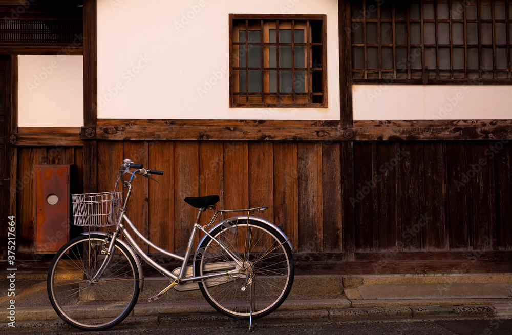 A vintage bike is parked on a street in Kyoto, Japan
