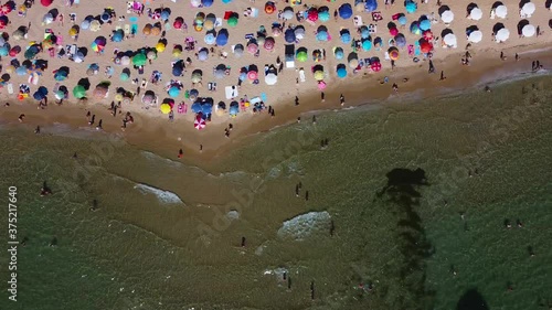 Beach with umbrellas in summer, drone shot