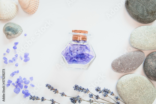 Background for relax. Flowers of lavender, sea salts, seastone on the white background. photo