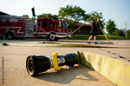 Firehouse: Firemen Resetting Fire Hose on Truck photo