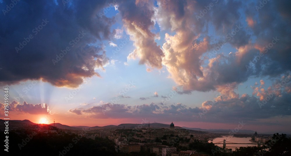 Setting sun with glowing clouds above Budapest Setting sun with glowing clouds above Budapest