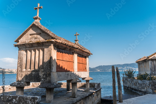 The old town of Combarro has the largest collection of horreos (typical granaries) and Cruceiros (traditional Calvary sculptures) in Galicia, the town is near Sanxenxo, Pontevedra, Spain. photo