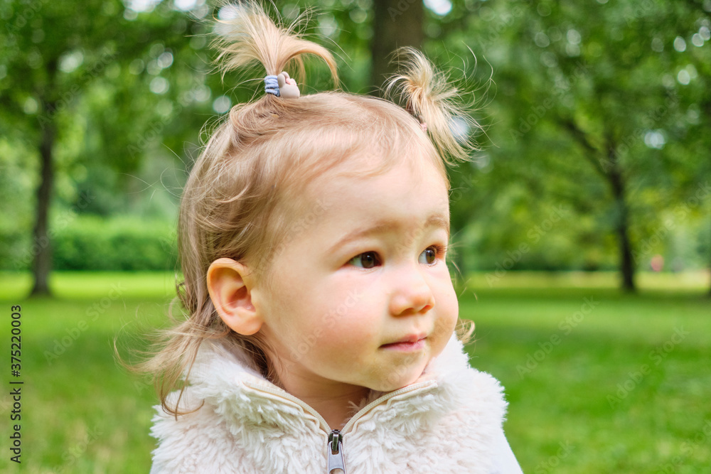 Portrait of Caucasian kid in the park. Close up. Portrait of Caucasian kid in the park. Close up.
