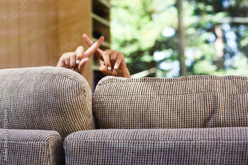 Person holding up their fingers in an x shape to say no photo