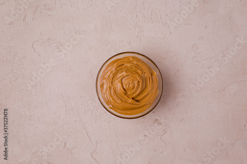 Peanut butter in a transparent cup. View from above. Copy space for your text