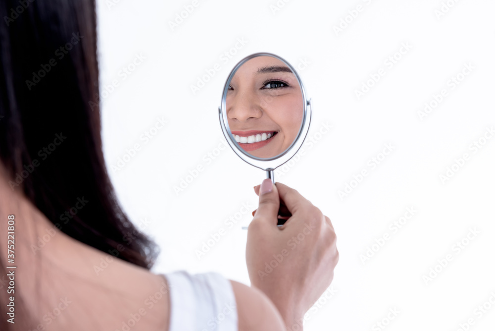 Close up images, Shadow of Asian attractive woman in the mirror, smiling Show clean white teeth, On white background, to people and beauty concept. Close up images, Shadow of Asian attractive woman in the mirror, smiling Show clean white teeth, On white background, to people and beauty concept.