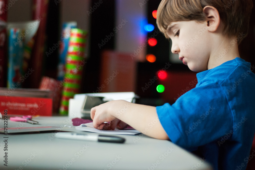 Boy wraps presents for Christmas Boy wraps presents for Christmas