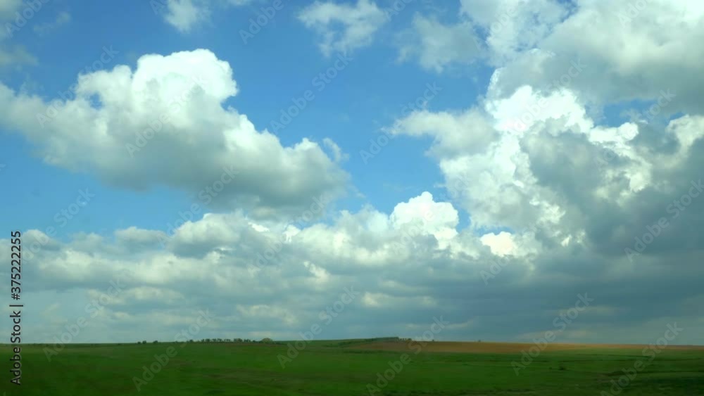 Side view of a Spanish road with meadows and mountains from inside a car with dirty glass, on a sunny day with some clouds. Side view of a Spanish road with meadows and mountains from inside a car with dirty glass, on a sunny day with some clouds.