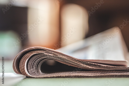 Folded newspapers on a table photo