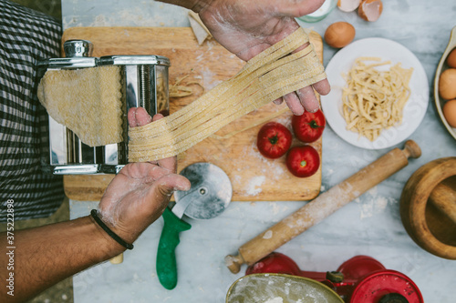 Man making fresh pasta with organic ingredients. photo