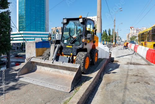 Lightweight and maneuverable construction bulldozer stands when repairing the road.