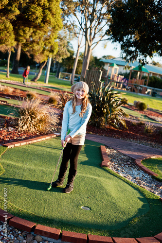 girl playing mini golf photo