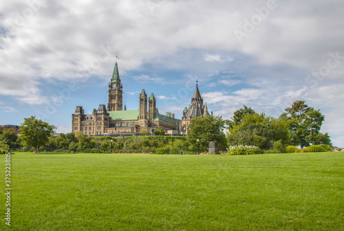Long sweeping view across lawn at Major's Hill Park with the Parliament Hill in the mid-ground with Peace Tower and Library of Parliament nobody