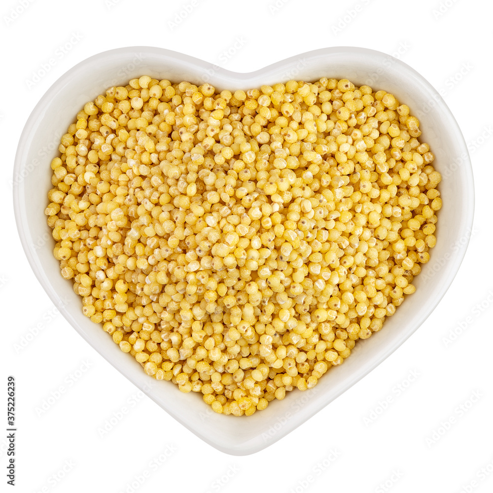 millet groats in heart shaped plate millet groats in heart shaped plate