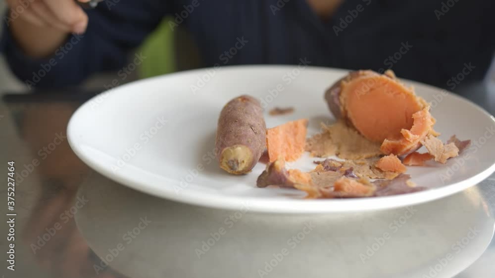 Interior Close Shot of Eating Sweet Potatoes in a Plate Interior Close Shot of Eating Sweet Potatoes in a Plate