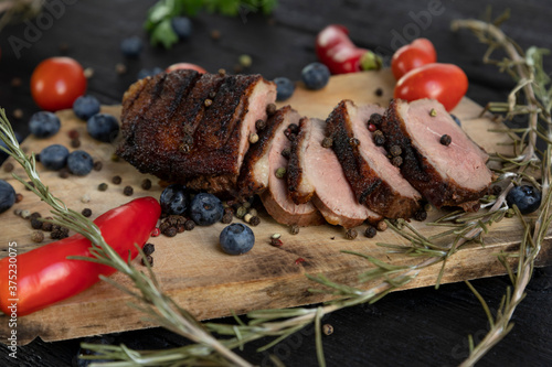 Quadro em tela Goose breast Christmas roast with blueberries, tomatoes, red peppers and rosemar