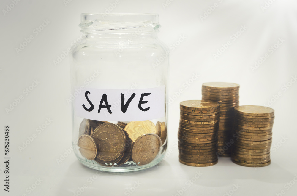 Stacks of money saving coins in a glass jar. Laundering of money. Business growth concept. Stack of coins. Savings for the future concept. Stacks of money saving coins in a glass jar. Laundering of money. Business growth concept. Stack of coins. Savings for the future concept.