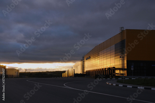 Warehouse logistics complex in the rays of the rising sun.