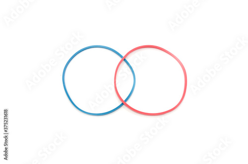 two rubber bands isolated on white background. Red and blue elastic band.