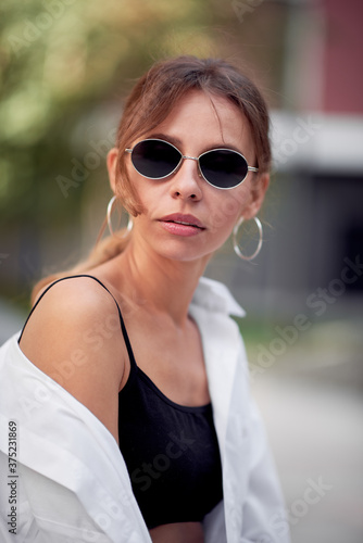 Woman in white shirt and sunglasses
