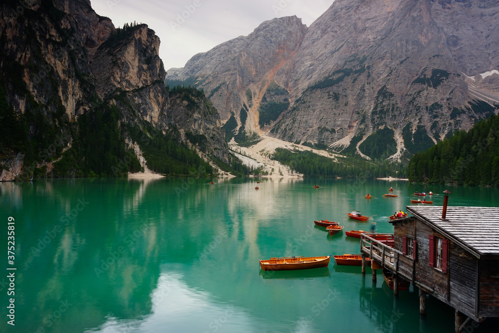 Boats leaving the dock early in the morning on Lago di Braies, Val Pusteria, Dolomites, Unesco, Trentino Alto Adige, Sudtirol, Italy