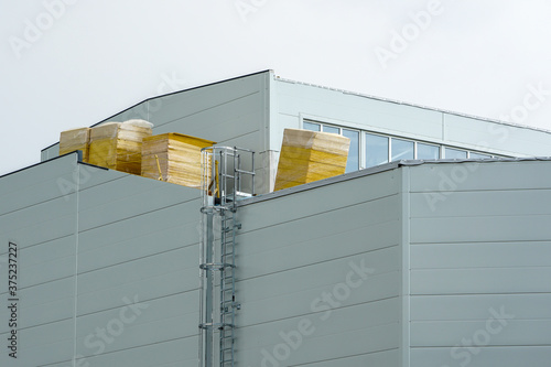 pallets with thermal insulation boards on the roof of the building photo