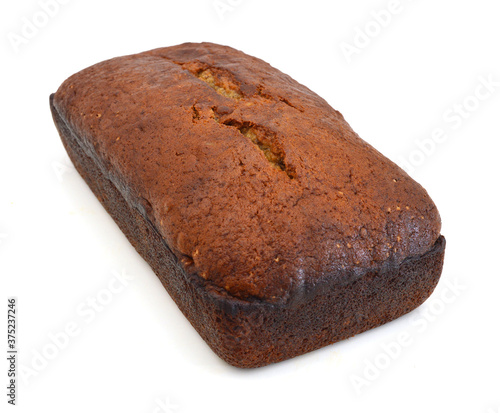 A fresh homemade loaf of banana walnut bread on white background