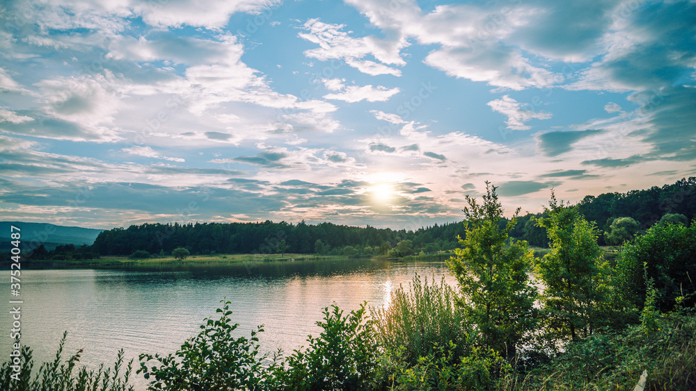Sunset at the lake in mountains. Dobrohostiv village. Sunset at the lake in mountains. Dobrohostiv village.