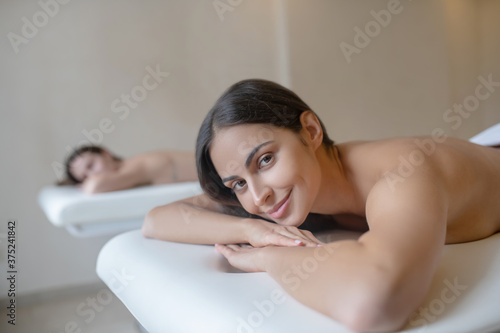 Close up picture of a woman lying on a couch before massage